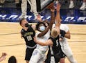 Caledonia’s Jackson Koepke (10) and Austin Klug (3) defend Minneapolis North’s Mario Sanders (1) under the basket in the Class 2A semifinal Wednes