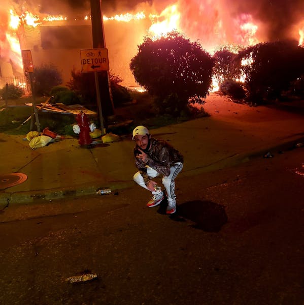 An image of Matthew Lee Rupert in front of a burning building in Minneapolis (Facebook) ORG XMIT: CgKql52krKbor-3jupD2