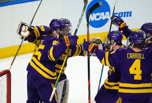 Minnesota State players surround goaltender Dryden McKay after beating the Gophers in the regional final.