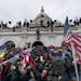 Pro-Trump supporters pushed back against police at the U.S. Capitol in Washington, D.C., on Jan. 6. A man who identified himself as a believer in the 