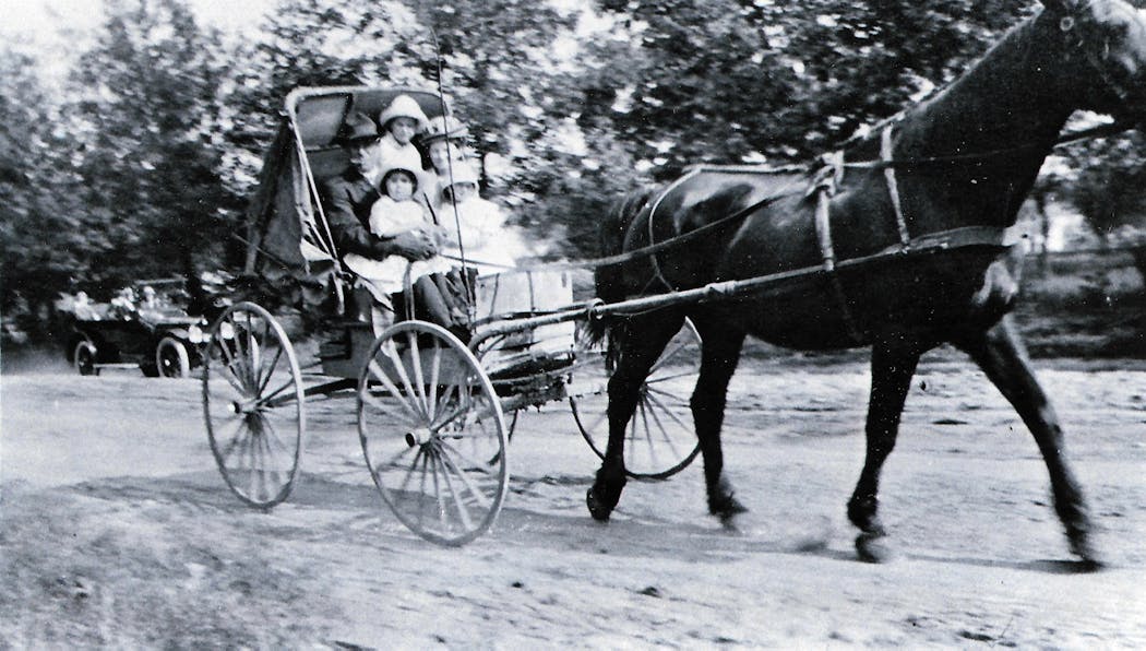 Erna Zahn as a child in 1915, riding in a horse and buggy near Pickett, Wisconsin with her siblings and parents. They were traveling to a family member's house on a Sunday afternoon.