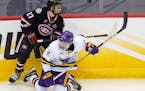 St. Cloud State forward Chase Brand (27) knocked down Minnesota State Mankato defenseman Akito Hirose (2) when the teams met in the Frozen Four on Apr