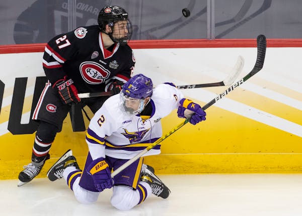 St. Cloud State’s Chase Brand knocked down Minnesota State Mankato defenseman Akito Hirose when the teams met in the Frozen Four on April 8, 2021 in