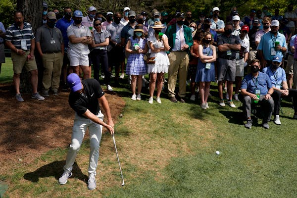 Rory McIlroy hits out of the rough on the sixth hole during the first round of the Masters