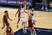 Alexandria’s Trevin Hoepner (25) shoots a jump shot in the first half over the arms of Richfield’s Ryan Miles (5) in the Class 3A semifinal Thursd