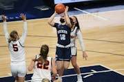 Becker’s Maren Westin (12) crosses the lane and pours in two of her 12 first half points against Marshall. The Bulldogs led the Tigers 37-24 at half