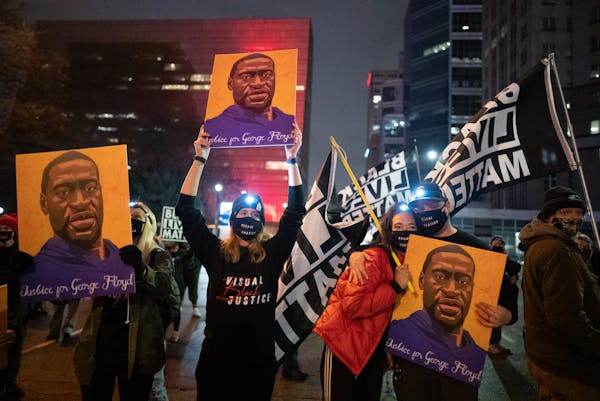 Members of Visual Black justice held signs together. ] Mark Vancleave – About a hundred protesters gathered for a late-evening demonstration against