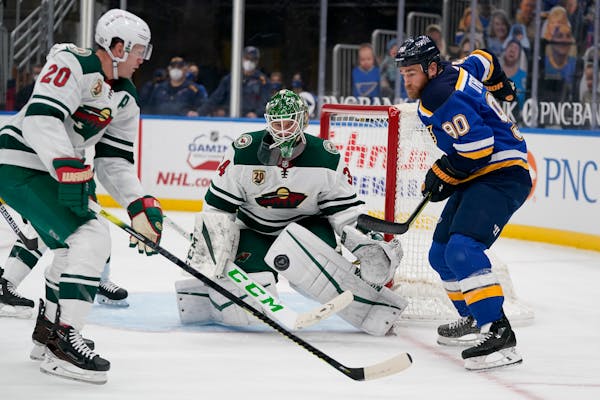 St. Louis Blues’ Ryan O’Reilly (90) watches the puck as Wild goaltender Kaapo Kahkonen and Ryan Suter defend during the second period Friday night