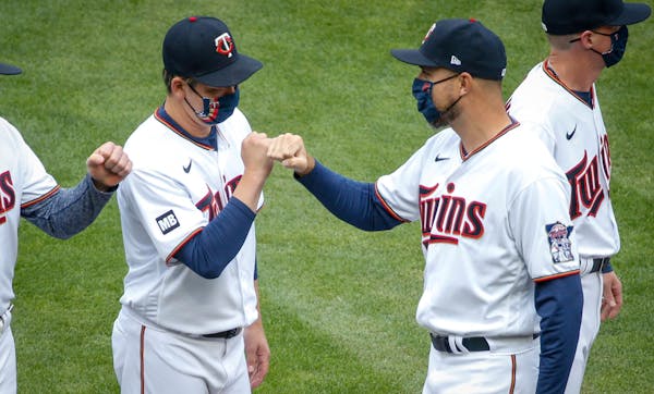 Kenta Maeda greets manager Rocco Baldelli during introductions during the home opener.