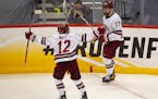 Massachusetts forward Garrett Wait (12) celebrated with Philip Lagunov after Lagunov’s shorthanded goal in the second period made it 3-0.
