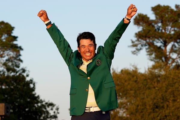 Hideki Matsuyama raised his arms in triumph after putting on the champion’s green jacket for his victory at the Masters on Sunday.