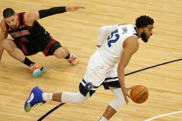 Wolves center Karl-Anthony Towns left Bulls counterpart Nikola Vucevic behind on the floor during the first quarter Sunday night at Target Center.