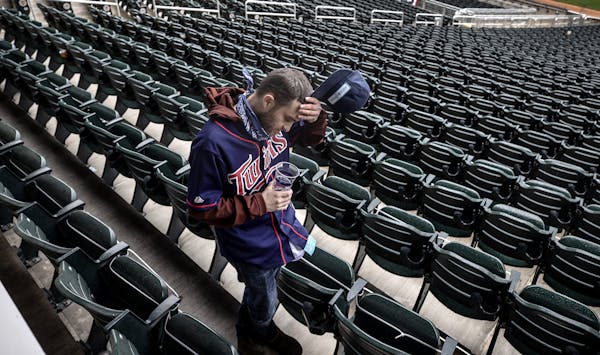 Twins fan Zack Kellner of Minneapolis left Target Field after the team announced that the series opener against Boston was postponed Monday.
