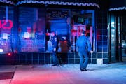 Minneapolis police officers check a damaged building on Lake Street early Monday, April 12, after Brooklyn Center Police fatally shot 20-year-old Daun