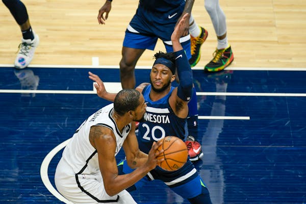 Timberwolves forward Josh Okogie defends against Brooklyn forward Kevin Durant during the second half on April 13.