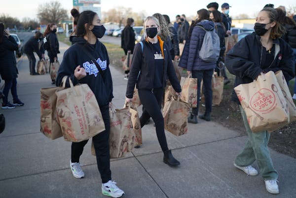 Macalester students Zoe Frederick, Elise Gryler and Sara Gregor delivered donated groceries and asked Brooklyn Center residents what else they could d