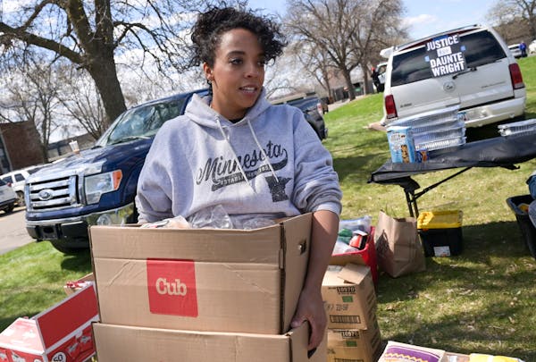 Rachel Nelson, with Twin Cities Relief, hauled a few boxes of food which would be served to community members at a barbecue outside the Kenyan Communi