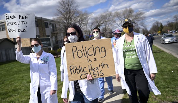 Health care workers, including University of Minnesota psychologist Christine Conelea, center, marched along Humboldt Avenue N. toward the Brooklyn Ce