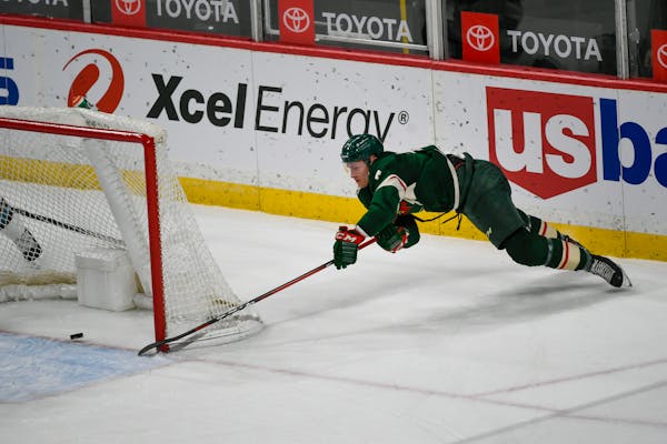 Wild center Nico Sturm makes a wraparound shot for goal against the San Jose Sharks during the second period