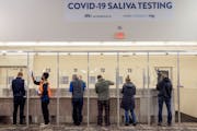 People took saliva COVID-19 tests at MSP Airport on Nov. 12, 2020. The Legislative Auditor’s Office is looking into complaints about the rates bille