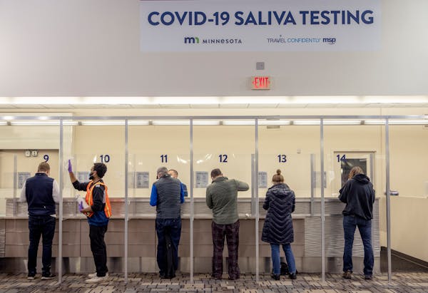 People took saliva COVID-19 tests at MSP Airport on Nov. 12, 2020. The Legislative Auditor’s Office is looking into complaints about the rates bille