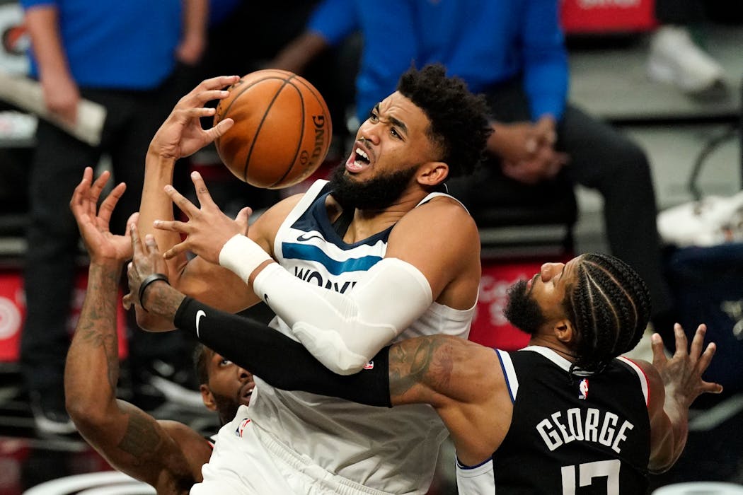 Wolves center Karl-Anthony Towns had the ball knocked from his hands by Clippers guard Paul George during the second half Sunday. Towns injured his right knee in the fourth quarter, but later said it was fine.