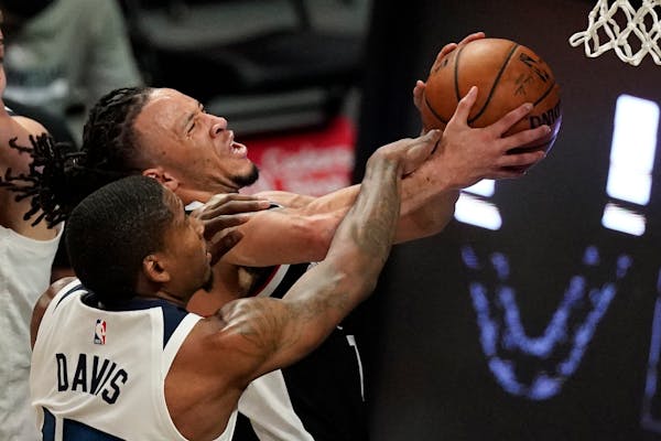 Clippers guard Amir Coffey attempted to shoot as Timberwolves center Ed Davis defended Sunday.