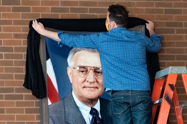 Vice President Walter Mondale’s portrait was draped with a black sash Tuesday morning at the University of Minnesota Law School. Mondale Hall is nam
