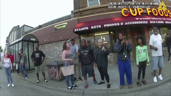 This May 25, 2020, file image from a police body camera shows bystanders including Alyssa Funari, left filming, Charles McMillan, center left in light