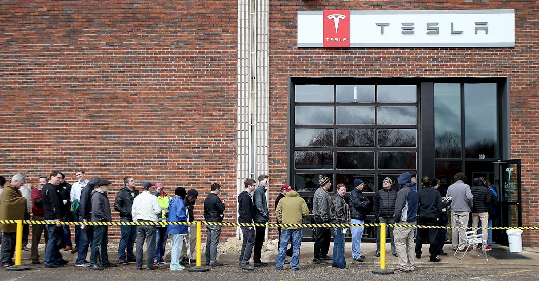 People lined up outside Tesla in Eden Prairie in 2016 to get on a waiting list for the new Model 3 electric car. 