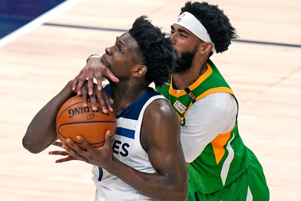 Utah guard Mike Conley defended against Wolves rookie Anthony Edwards in the first half Saturday night in Salt Lake City.