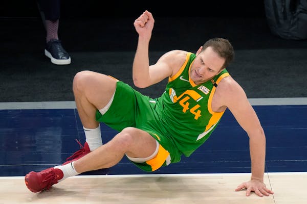Jazz forward Bojan Bogdanovic fell after making a three-pointer against the Wolves on Saturday night.