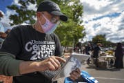 Census worker Daniel Crawford gathered information from a person in the Cedar-Riverside area of Minneapolis last September during a food drive.