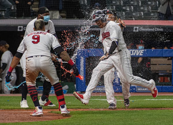 Cleveland’s Jordan Luplow got drenched by Eddie Rosario and his teammates after hitting a two-run home run off Twins reliever Alexander Colome in th