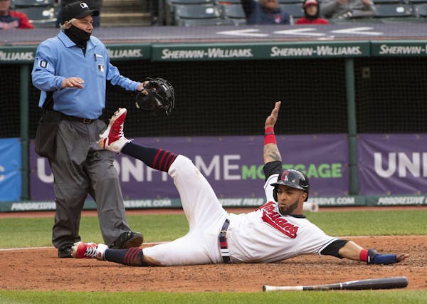 A sliding Eddie Rosario made it clear he was safe at home with Cleveland’s tying run in the sixth.