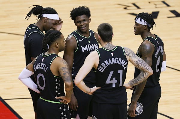 Minnesota Timberwolves forward Anthony Edwards and teammates huddle as time runs down during the fourth quarter of the team’s win over Houston.