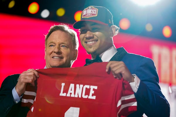 Trey Lance with NFL Commissioner Roger Goodell Thursday night at the NFL draft in Cleveland.