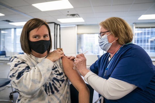 Christine Runyon administered the Moderna COVID-19 vaccine to Jamie Larson last month at United Labor Center in Minneapolis. ] LEILA NAVIDI • leila.