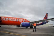 Sun Country Airlines, reporting quarterly results for the first time, gave an upbeat outlook for summer. File photo of CEO Jude Bricker with one of it