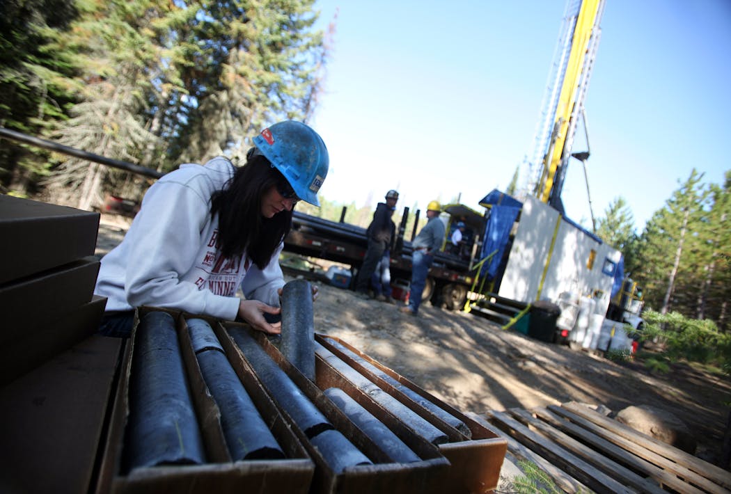Geologist Gina Raymond looked at the metal content of freshly drilled core at a drilling site near Ely, Minn. in 2011.