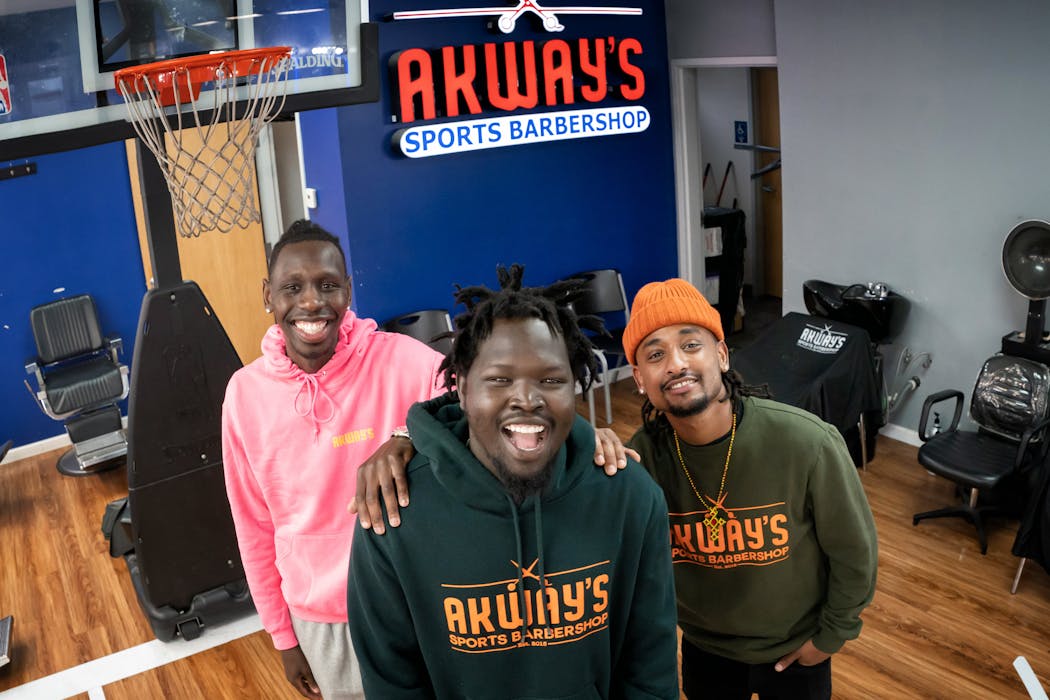 Akeem Akway, owner, Akway's Sports Barbershop in Mounds View, with cousins and business partners Amane Akane, left, and Nathan Sheferaw, right.