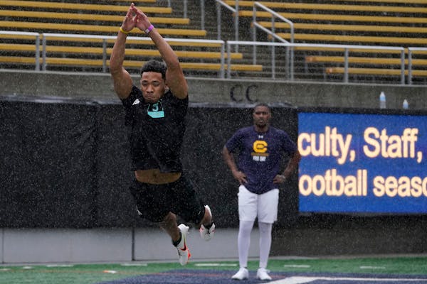 California’s Camryn Bynum, left, jumps in front of Jordan Duncan as they participate in the school’s pro day football workout for NFL scouts in Be