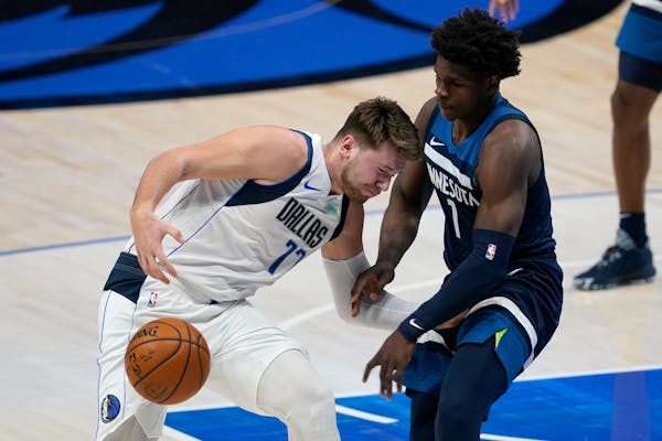  Mavericks guard Luka Doncic loses control of the ball as he works against Wolves rookie Anthony Edwards, the No. 1 ovverall draft choice in 2020.