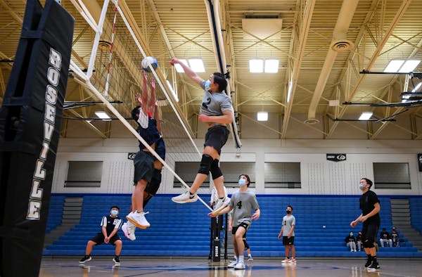 Pengsu Thao spiked the ball against Hmong Prep Academy players late in the third and final set of Wednesday night’s match.