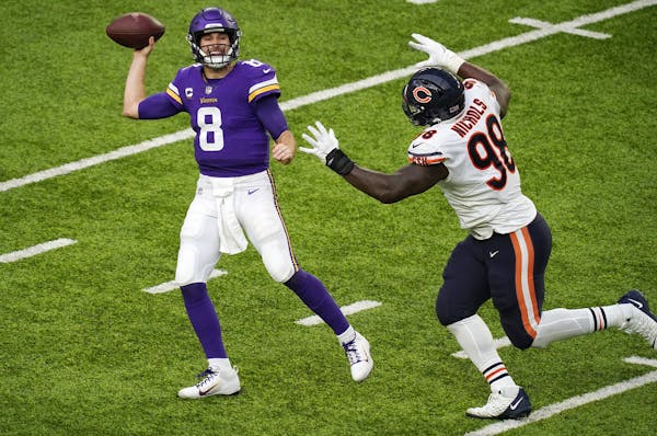 Minnesota Vikings quarterback Kirk Cousins (8) threw under pressure from Chicago Bears nose tackle Bilal Nichols (98) in the third quarter. ] ANTHONY 