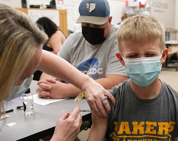 Lincoln Schlagel, 13, of Howard Lake, Minn., winced as he got his first dose of the Pfizer COVID-19 vaccine Thursday at Children’s Minnesota.