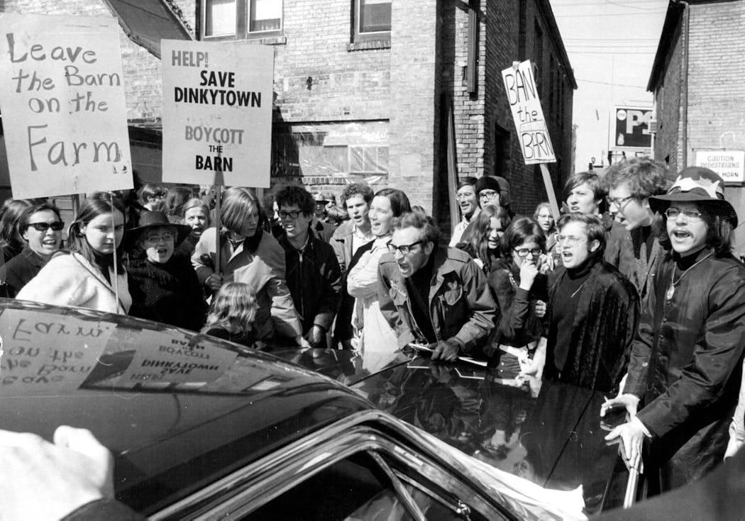 Protestors confront a Red Barn official and the property owner of the proposed Red Barn site in March 1970.