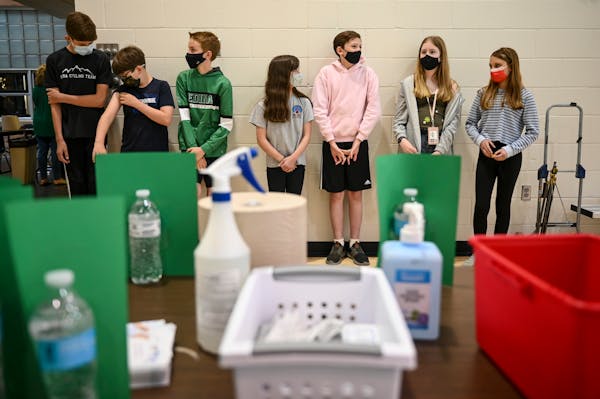 A group of masked South View Middle School students waited nervously for their first doses of the Pfizer-BioNTech COVID-19 vaccine Friday afternoon in