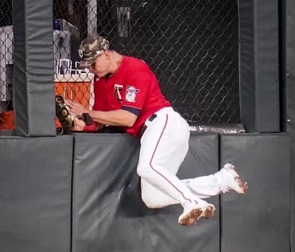 Twins center fielder Max Kepler caught a fly ball as he crashed into the wall in the third inning Friday night.