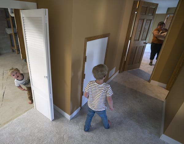 Utah transplant Rachel Bryant and her sons Ezra, 3, and Seth, 5, in the basement of their new Elk River home.